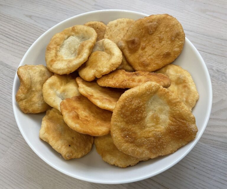 Golden dough snacks in a white bowl.