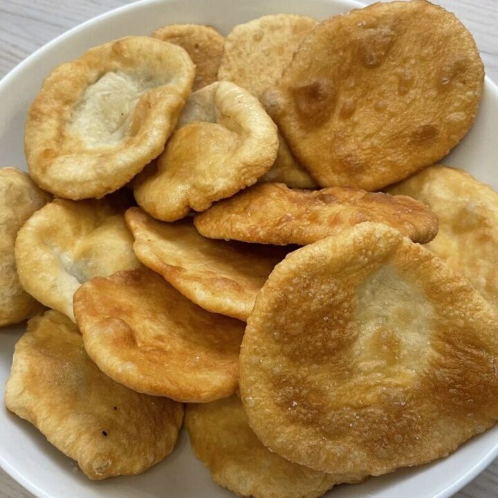 Golden dough snacks in a white bowl.