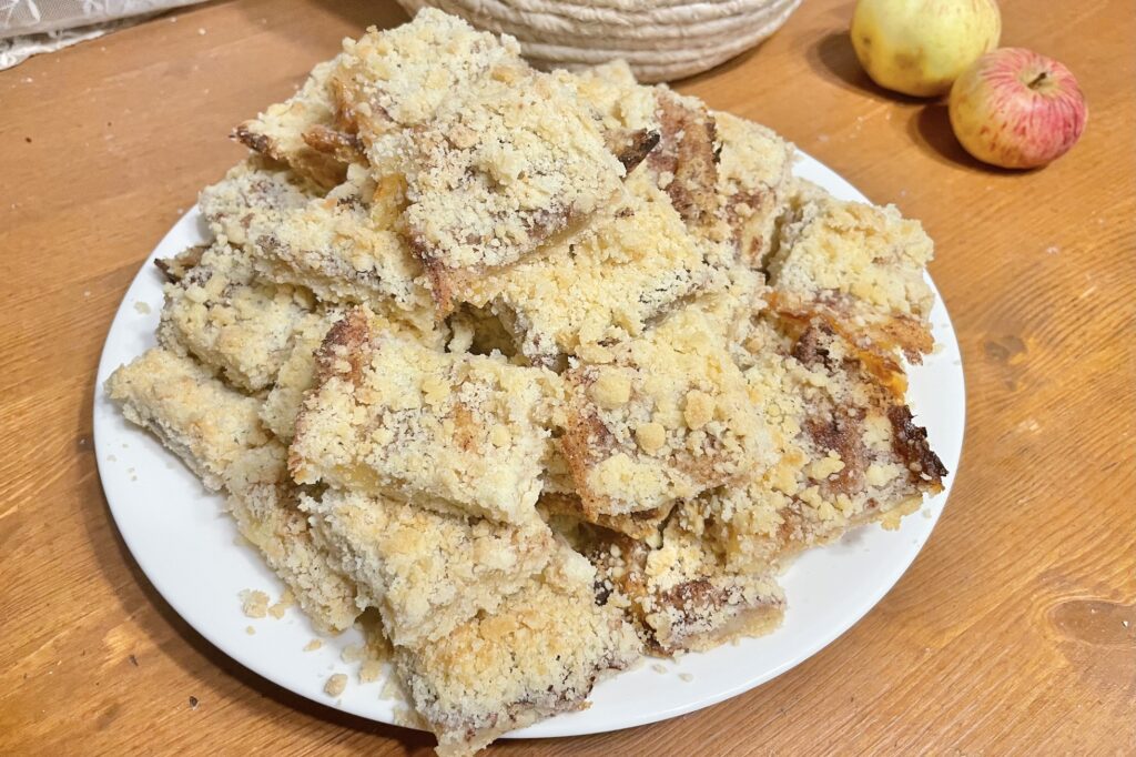 Apple crumble pie on a white plate.