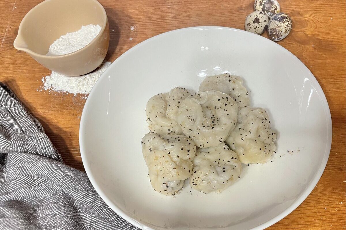 Served dumplings in a white bowl.