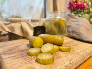 Fermented cucumbers and a pink flower.