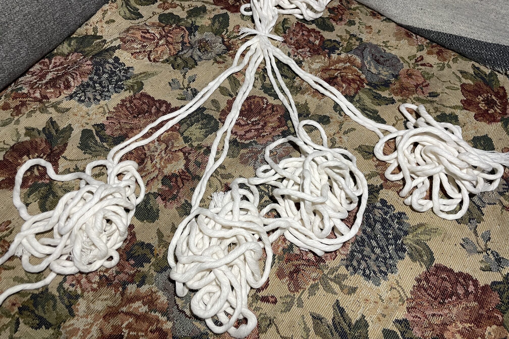 Divided white macrame cords.