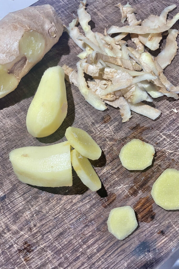 Peeled ginger on a cutting board.